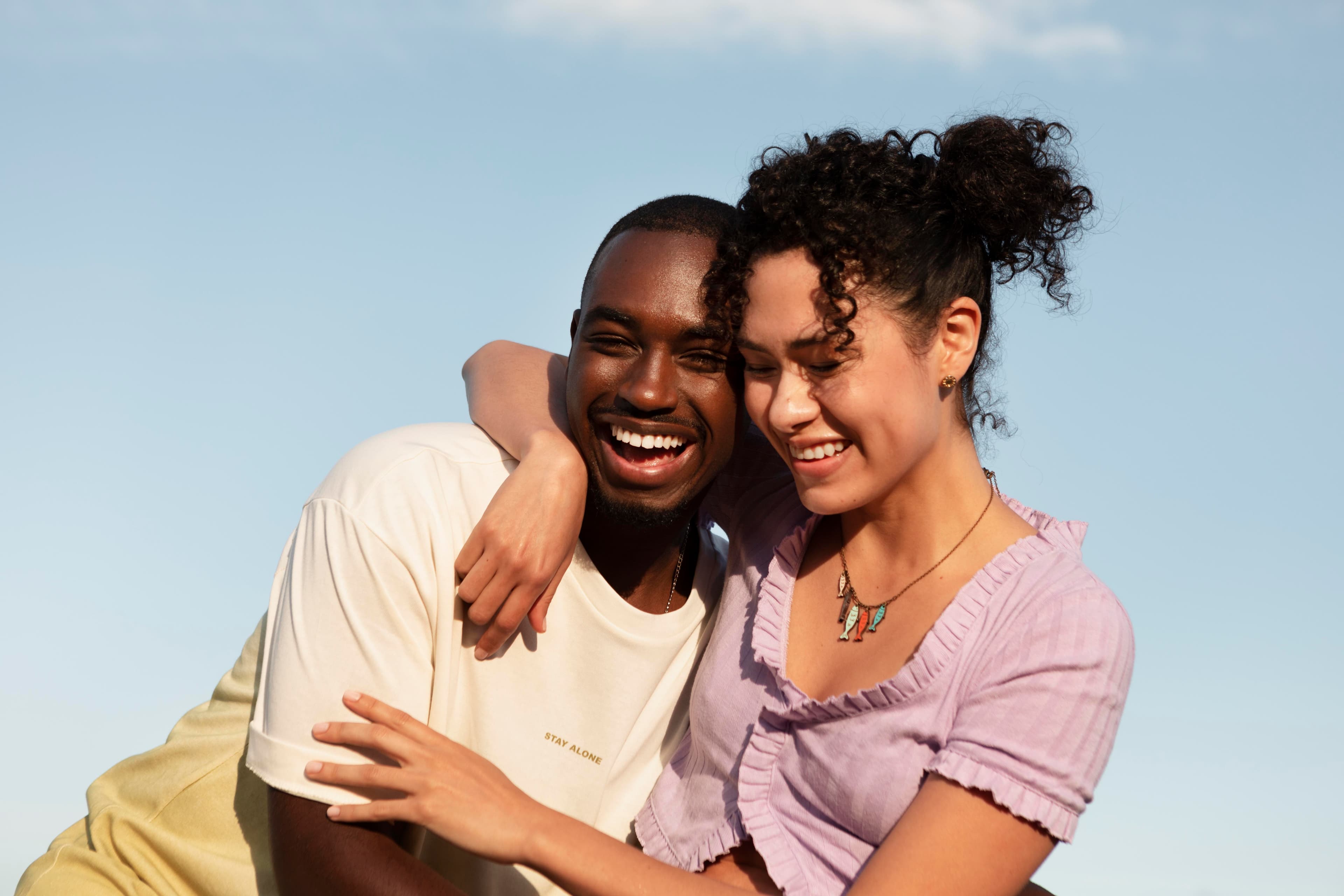 A couple laughing together outdoors
